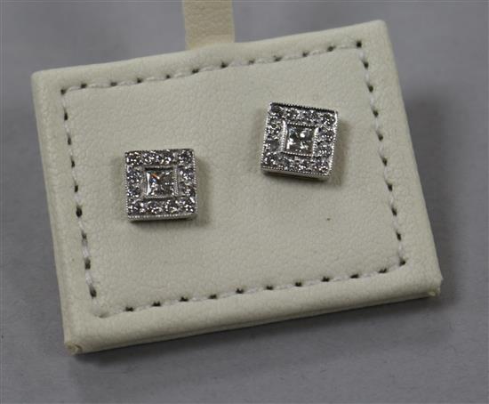 A pair of modern 18ct white gold and diamond cluster tablet ear studs with central princess cut stone, 7mm.